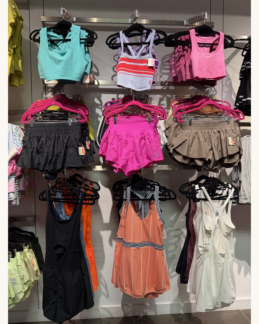 Wall of activewear tops, shorts and dresses
